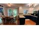 Eat-in kitchen featuring granite countertops, white cabinets, and a breakfast table near the window at 1310 Larkview Sw Dr, Lilburn, GA 30047