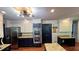 A stylish kitchen features granite countertops, stainless steel appliances, and modern lighting at 1310 Larkview Sw Dr, Lilburn, GA 30047