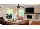 A cozy living room features a brick fireplace, hardwood floors, and a comfortable leather couch at 1310 Larkview Sw Dr, Lilburn, GA 30047