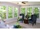Sunroom with views of the greenery, comfortable seating, and plenty of light at 1310 Larkview Sw Dr, Lilburn, GA 30047