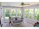 Sunroom filled with natural light, comfortable seating, and large windows overlooking a lush backyard at 1310 Larkview Sw Dr, Lilburn, GA 30047