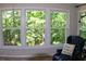 Bright sunroom with large windows, comfortable seating, and a beautiful view of the trees at 1310 Larkview Sw Dr, Lilburn, GA 30047