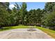 Spacious backyard with mature trees and patio area at 305 Hickory Pointe Ct, Villa Rica, GA 30180