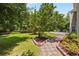 Landscaped backyard with patio and mature trees providing ample shade at 305 Hickory Pointe Ct, Villa Rica, GA 30180