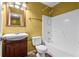 A bathroom featuring a sink with wood cabinet, toilet, and bathtub with shower at 305 Hickory Pointe Ct, Villa Rica, GA 30180