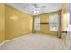 Bright bedroom with ample sunlight, ceiling fan, and neutral carpeting at 305 Hickory Pointe Ct, Villa Rica, GA 30180
