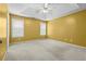 Spacious bedroom with a tray ceiling, ceiling fan, and carpet at 305 Hickory Pointe Ct, Villa Rica, GA 30180