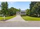Inviting two-story home with a long driveway, lush green lawn, and classic curb appeal at 305 Hickory Pointe Ct, Villa Rica, GA 30180