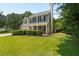 Attractive two-story home with a chimney, manicured bushes, and a well-kept front lawn at 305 Hickory Pointe Ct, Villa Rica, GA 30180