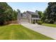 Beautifully landscaped home with a two-car garage, charming front porch, and a well-maintained lawn at 305 Hickory Pointe Ct, Villa Rica, GA 30180