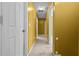 Hallway with white doors, beige carpet and yellow walls at 305 Hickory Pointe Ct, Villa Rica, GA 30180