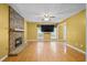 Bright living room featuring a stone fireplace, hardwood floors, and a ceiling fan at 305 Hickory Pointe Ct, Villa Rica, GA 30180