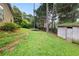 Spacious backyard with lush greenery, a trampoline, and a storage shed, perfect for outdoor activities at 5016 Comanche Nw Ct, Lilburn, GA 30047