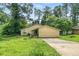 Cozy one-story home featuring a covered porch and driveway amid lush, mature trees at 5016 Comanche Nw Ct, Lilburn, GA 30047