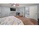 Relaxing main bedroom featuring a ceiling fan, large bed, and ample natural light at 5016 Comanche Nw Ct, Lilburn, GA 30047