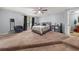 Spacious main bedroom featuring a seating area, ceiling fan, and en suite bathroom at 5016 Comanche Nw Ct, Lilburn, GA 30047