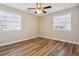 Bedroom featuring wood floors, ceiling fan and two windows at 5119 Ne Worsham St, Covington, GA 30014