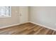 Well-lit bedroom with wood-look flooring and a modern neutral paint at 5119 Ne Worsham St, Covington, GA 30014