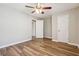 A bedroom with new floors features 2 doors and a ceiling fan at 5119 Ne Worsham St, Covington, GA 30014