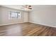 Inviting bedroom with wood-look floors, a ceiling fan, neutral paint and light from a window at 5119 Ne Worsham St, Covington, GA 30014