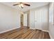 Bedroom features wood floors, ceiling fan and walk through to the next room at 5119 Ne Worsham St, Covington, GA 30014