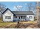 Charming exterior showcasing a freshly painted white home with black trim, a cozy front porch, and landscaped garden at 5119 Ne Worsham St, Covington, GA 30014
