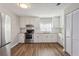 Well-lit kitchen with stainless steel appliances, white cabinets, granite countertops and wood floors at 5119 Ne Worsham St, Covington, GA 30014