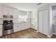 Bright kitchen featuring stainless steel appliances, granite countertops, and white cabinets at 5119 Ne Worsham St, Covington, GA 30014