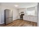 Bright kitchen features stainless steel appliances, wood floors, white cabinets, and granite countertops at 5119 Ne Worsham St, Covington, GA 30014