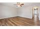 Bright living room featuring wood-look floors, a ceiling fan, neutral paint, and an open doorway at 5119 Ne Worsham St, Covington, GA 30014