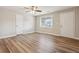 Inviting living room with wood-look floors, a ceiling fan, natural light and three entry doors at 5119 Ne Worsham St, Covington, GA 30014
