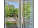 Balcony featuring decorative metal railing and view of mature landscaping at 531 Headwind Way, Alpharetta, GA 30005