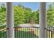 View from balcony with decorative metal railing and view of mature landscaping at 531 Headwind Way, Alpharetta, GA 30005