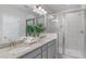 Bathroom featuring double sinks with granite countertops and a sleek glass-enclosed shower at 531 Headwind Way, Alpharetta, GA 30005