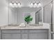 Bathroom with a double vanity, granite countertop, modern fixtures, and a glass-enclosed shower at 531 Headwind Way, Alpharetta, GA 30005