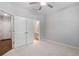 Cozy bedroom with plush carpeting, ceiling fan, and ensuite access at 531 Headwind Way, Alpharetta, GA 30005
