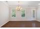 Dining room with hardwood floors, a chandelier and a door to the outside at 531 Headwind Way, Alpharetta, GA 30005