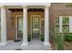 Up-close front entrance featuring stately columns and olive-painted doors at 531 Headwind Way, Alpharetta, GA 30005