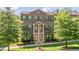Beautiful townhome featuring a covered entrance, shuttered windows, and a well manicured lawn at 531 Headwind Way, Alpharetta, GA 30005