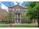 Classic brick townhome with shuttered windows, covered entrance, and meticulously manicured lawn at 531 Headwind Way, Alpharetta, GA 30005