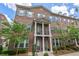 Classic brick townhome with shuttered windows, covered entrance, and manicured landscaping at 531 Headwind Way, Alpharetta, GA 30005