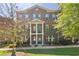 Classic brick townhome with shuttered windows, covered entrance, and manicured landscaping at 531 Headwind Way, Alpharetta, GA 30005
