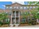 Beautiful townhome featuring a covered entrance, shuttered windows, and manicured landscaping at 531 Headwind Way, Alpharetta, GA 30005