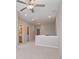 Upstairs hallway featuring a ceiling fan and doorways to the bathroom and laundry room at 531 Headwind Way, Alpharetta, GA 30005