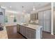 Bright eat-in kitchen featuring gray cabinets and a large granite island at 531 Headwind Way, Alpharetta, GA 30005