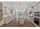 A modern kitchen showcases gray cabinets, granite countertops, stainless steel appliances, and hardwood floors at 531 Headwind Way, Alpharetta, GA 30005