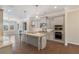 Open-concept kitchen with gray cabinets, stainless steel appliances, granite countertops, and hardwood floors at 531 Headwind Way, Alpharetta, GA 30005