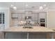 Close up of a kitchen island with gray cabinets and granite countertops with stainless steel sink at 531 Headwind Way, Alpharetta, GA 30005