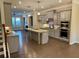 Modern kitchen featuring stainless steel appliances, granite counters, island, and hardwood floors at 531 Headwind Way, Alpharetta, GA 30005