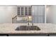 Kitchen island with granite countertops and stainless steel sink with gray cabinets at 531 Headwind Way, Alpharetta, GA 30005